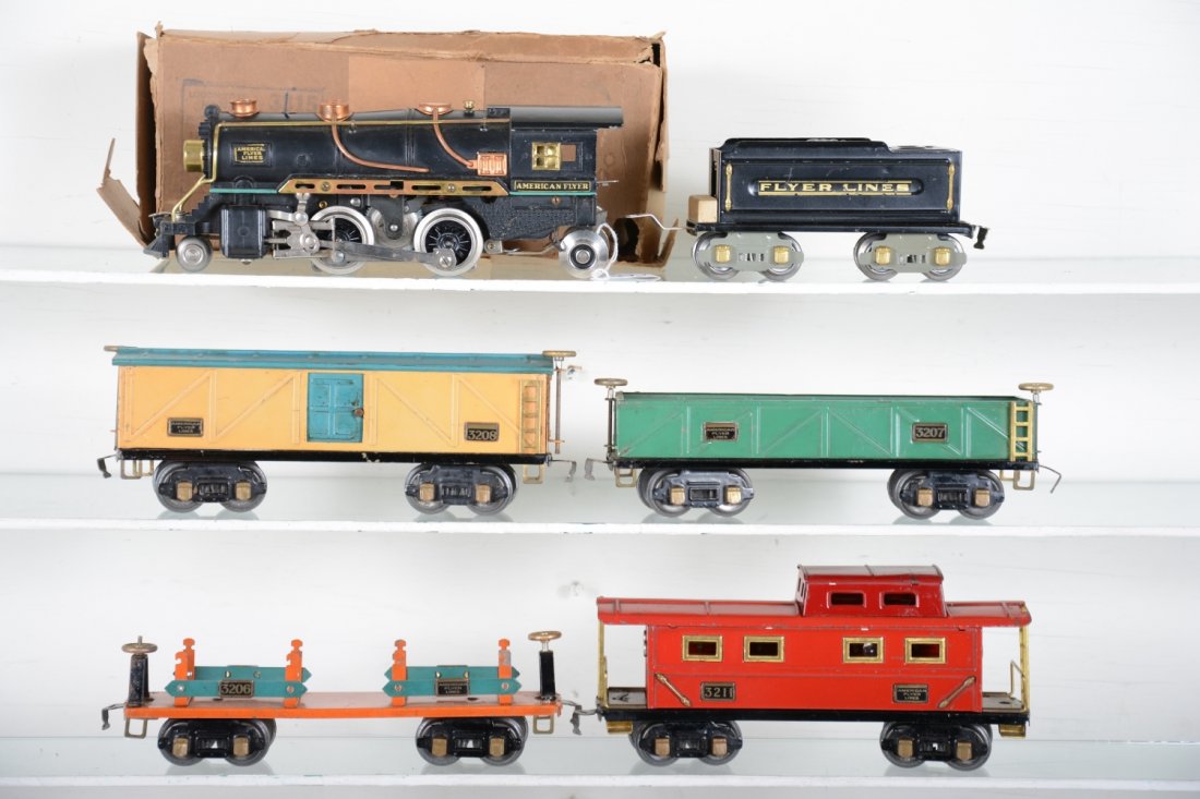 American Flyer Steam Freight Set: Circa 1937. Includes a 3315 steam loco with reverse & bell, worn box; restored 3189 tender; 3207 sand car; 3208 boxcar; 3218 machinery car; 3211 caboose. Rest show light top moderate playwear, C6-7