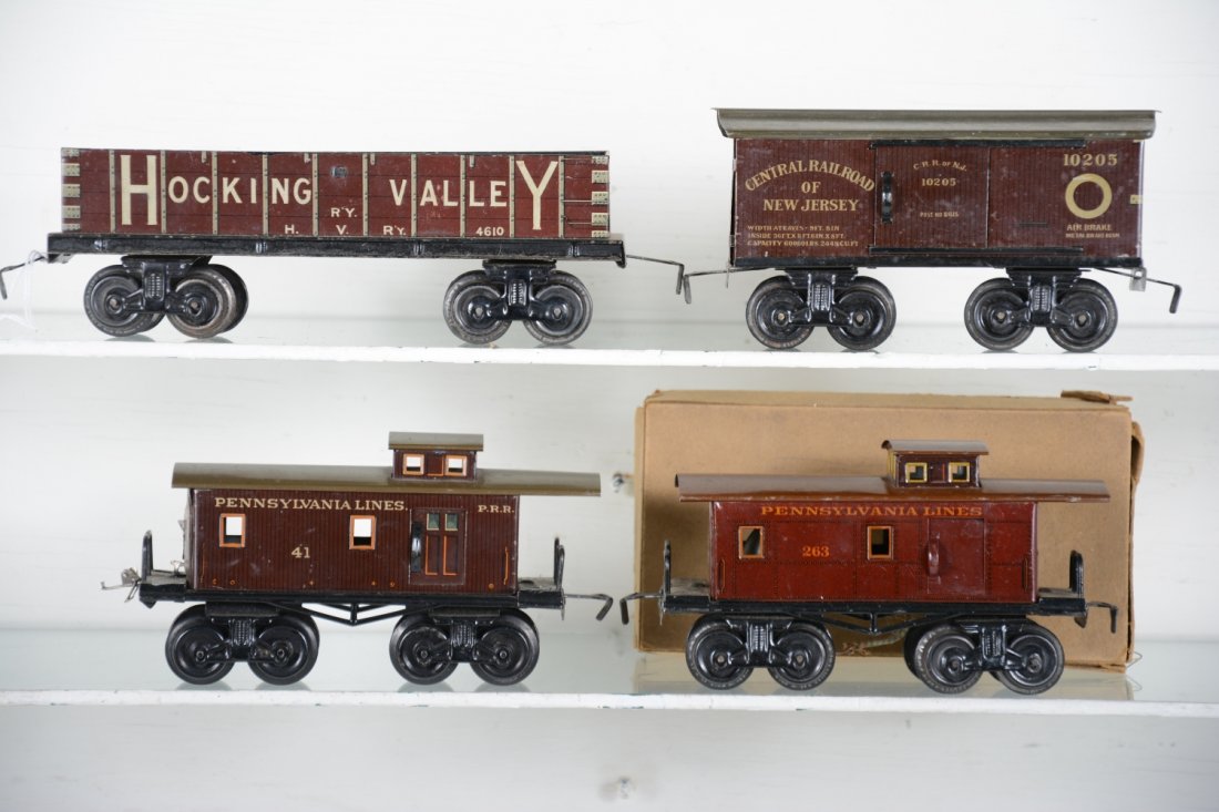 4 Bing American Freight Cars: Includes a Hocking Valley gondola; CNJ boxcar; 41 PRR caboose; boxed 263 PRR caboose. All show light to moderate playwear, C7-8