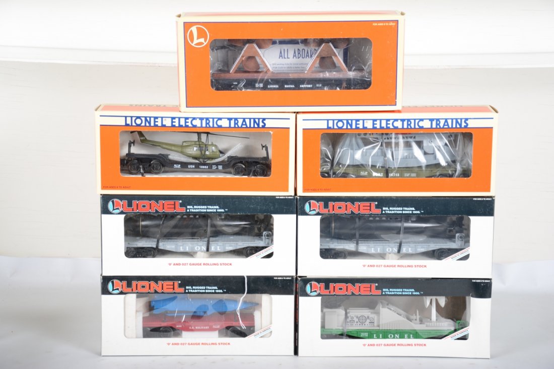 Lionel Military Cars: Includes 16718 USMC missile launcher; 16952 USN flat with helicopter; 36016 flat with propellers; 2 #16351 flat with submarine; 16652 radar car; 16352 Cruise missile car. All are new in boxes, C10