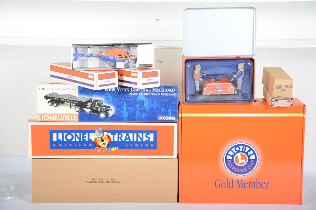 Unusual Lionel Items Group: Includes a Schylling wind-up train station & handcar; Gold Member presentation box; Ink Well Diecast billboard set; TMT 18418 truck with helicopter with 2 extra separate sale copters; B801 replacement
