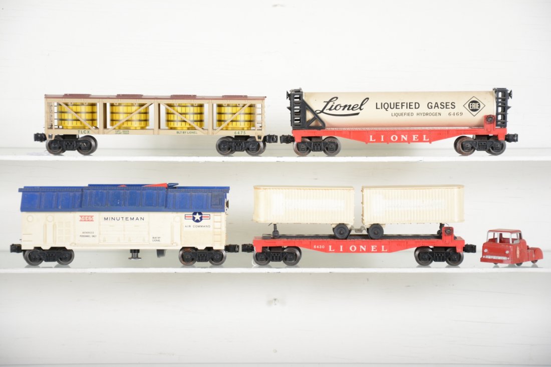 Lionel Freight Cars: Includes 6431 flat with trailers and enhanced Midgetoy tractor; 3665 Minuteman launcher; 6475 pickle car; 6469 liquefied gasses car, 1 end piece loose. All could benefit from a light cleaning, but onl