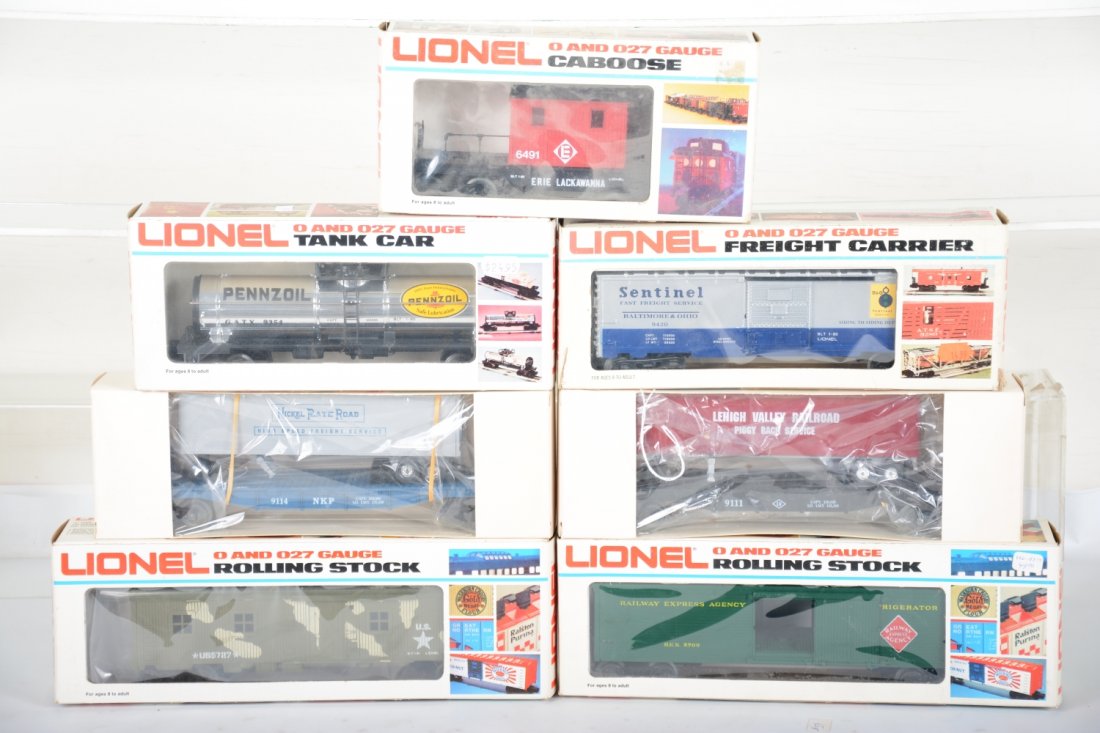 Modern Freight Cars: Includes 9111 LV trailer flat; 9114 NKP trailer flat; Lionel 5727 US Marines bunk car; 9354 Pennzoil tank; 9420 B&O boxcar; 5709 REA reefer; 6491 Erie transfer caboose. All appear new in boxes, C9-10