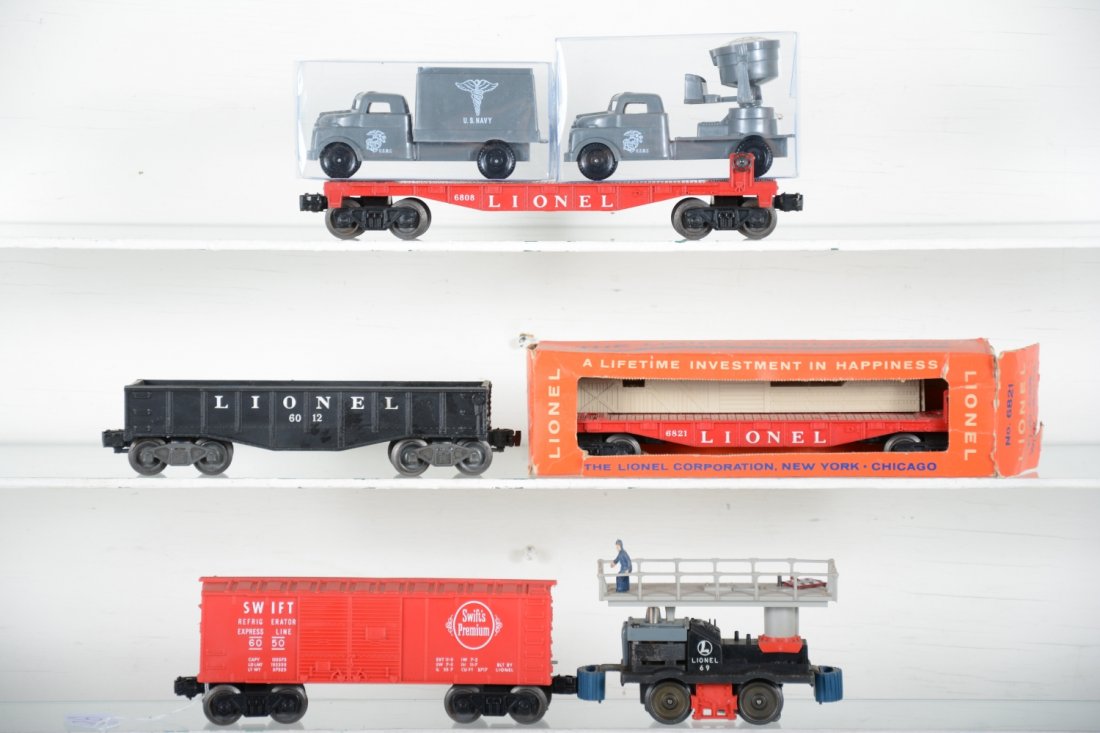 Lionel Group: Includes a 65 maintenance car, replaced top & sign; 6808 flat with repro military vehicles; 6821 flat it crates, worn ob; 6050 Swift's bank car; 6012 gondola; All show light playwear, C7-7+