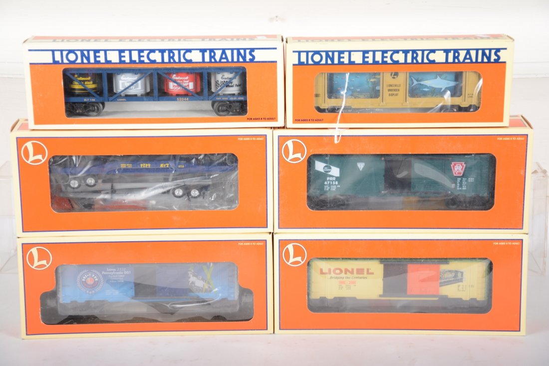 Lionel Freight Cars: Includes 16681 Animated aquarium car; 29294 Hellgate boxcar; 29297 PRR No Damage boxcar; 29227 Century Club boxcar; 9474 Flat with trailer frames; 52044 east wood vat car. All appear like new with box