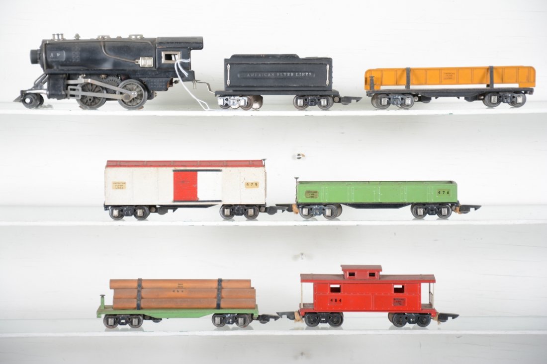 American Flyer 3/16 Steam Freight Set: Includes a 401 steam loco, missing g trailing wheels; 416 tender; 478 boxcar; 476 sand car; 483 girder car; 482 log car; 484 caboose, all have intact couplers and could benefit from a cleaning. They s