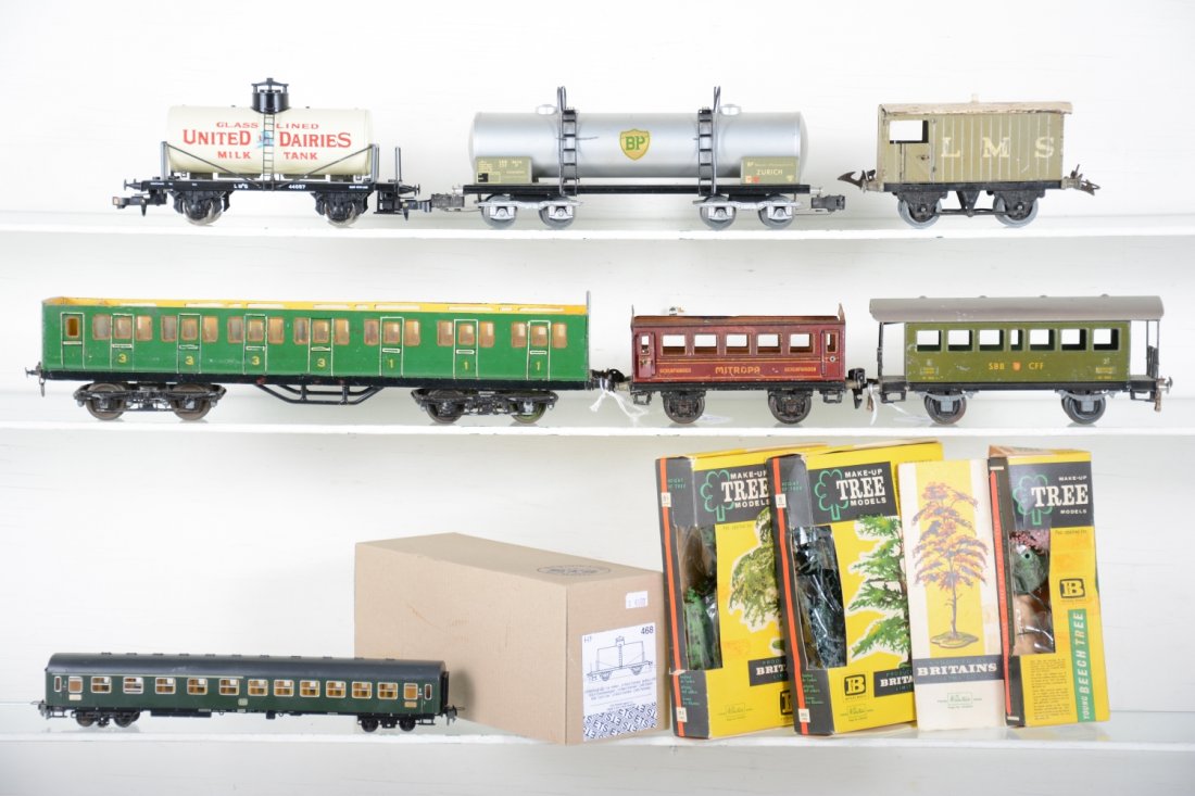 European Train Lot: Includes an HO lighted coach; boxed ETS United dairies car; Buco 10" BP tank car; Buco Swiss coach; Marklin Mitropa sleeper, no roof; Hornby LMS brake van; Leeds wooden coach, missing roof. Various gr