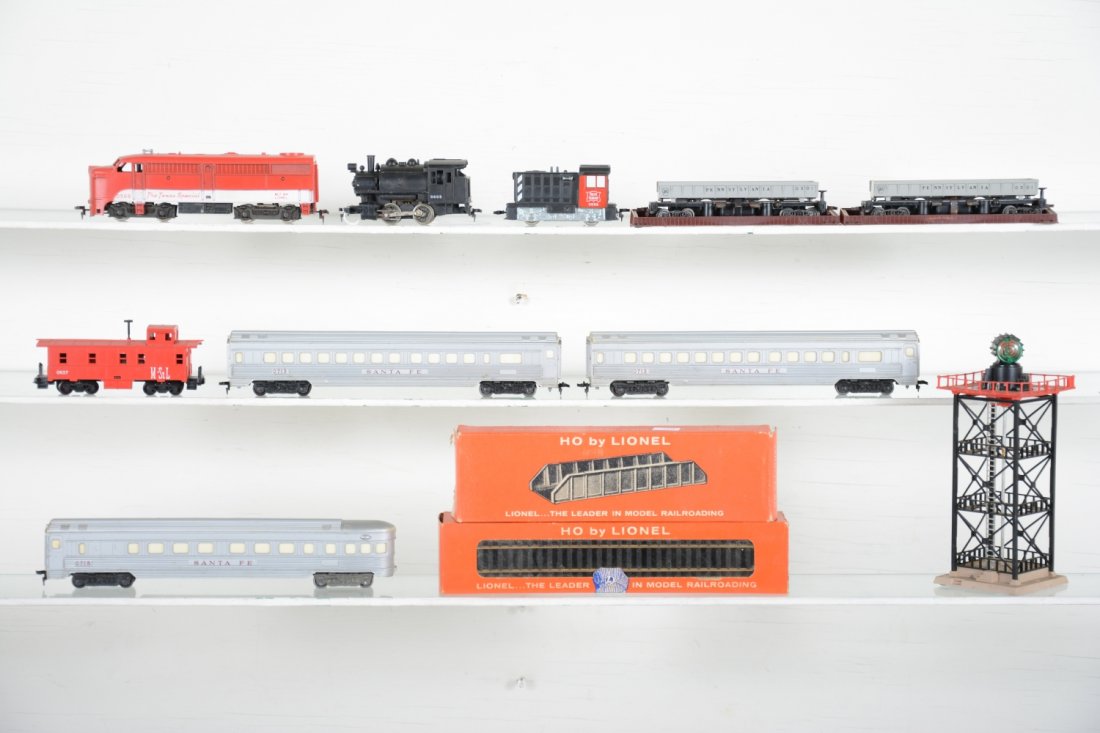 Lionel HO Trains Lot: Includes an 0566 TS Alco; 0058 RI diesel; 0605 0-4-0 tank loco; 2 #0715 SF coaches; 0714 observation; 0494 beacon; 2 #0301 PRR coal dump cars with bins; 0837 M&StL caboose. All show light playwear, C7