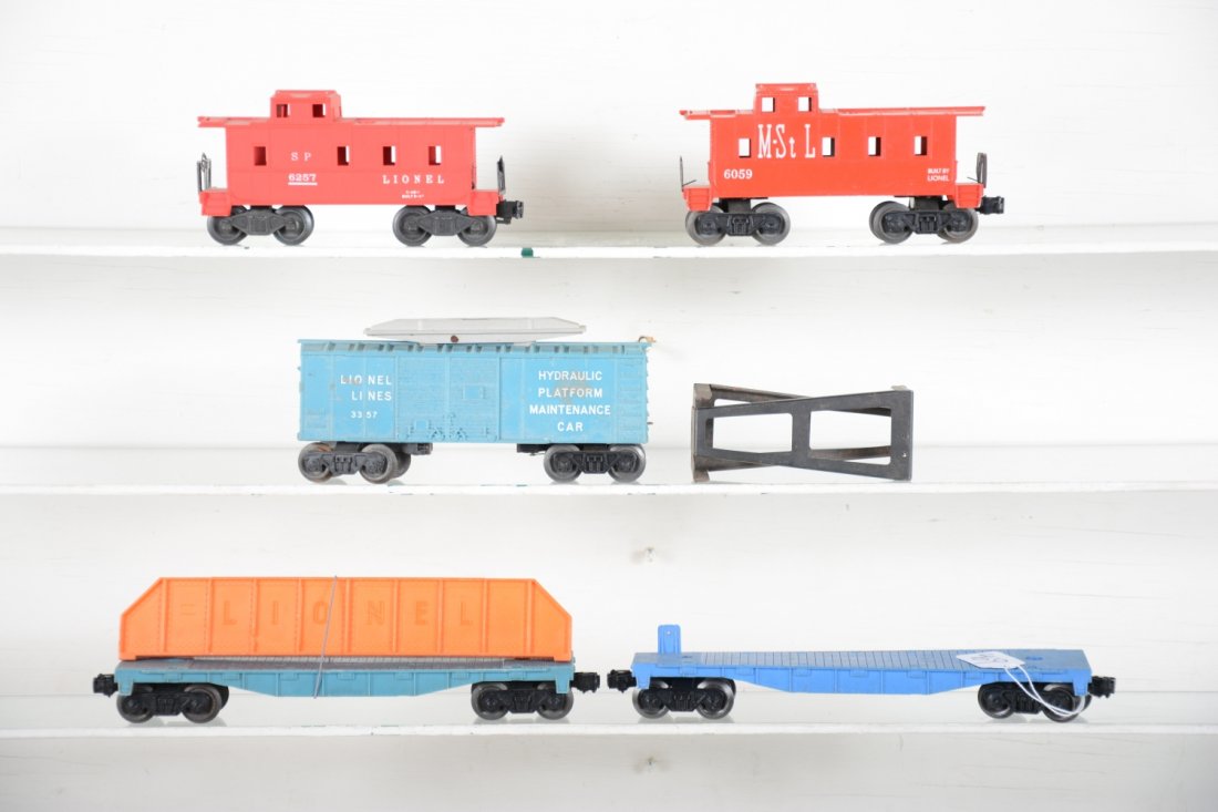5 Unusual Lionel Freight Cars: Includes a painted 6059 M&StL caboose; teal blue 6502 flat with girder; teal blue 3357 Cop'n Hobo car, 2 partial platform, C6; 6502 translucent blue flat car; 6257 light red painted caboose, C8, rest 