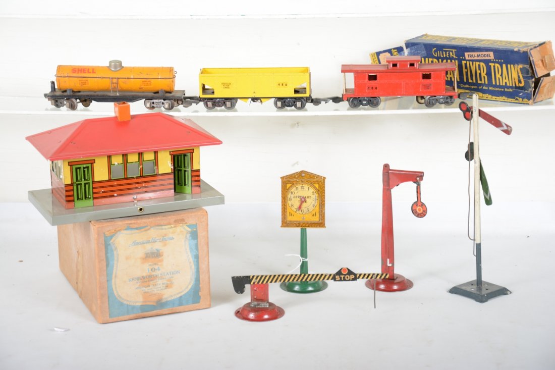 Pre War American Flyer Lot: Includes a boxed 104 Kennilworth station; crossing gate, banjo signal and station clock; 480 Shell tank, C5; 486 hopper; boxed 484 caboose; Ives double semapohore. Rest show light playwear, C7-8