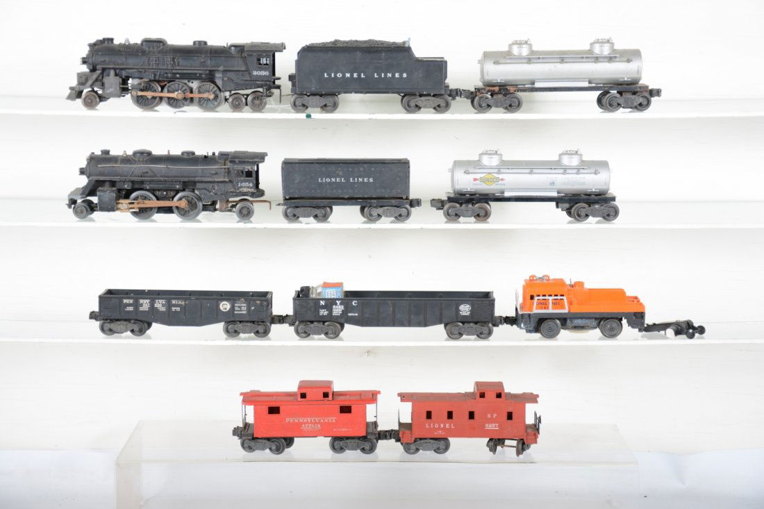 Lionel Postwar Group: Includes a 2036 Loco, rusty rods; 6466W tender, chip near coal pile top; 1654 loco; 1654T Tender; 6465 tab car; 2465 tank car; 6462 gondola; 2452 gondola; 6257 caboose, top damaged, cab loose; 2472 ca