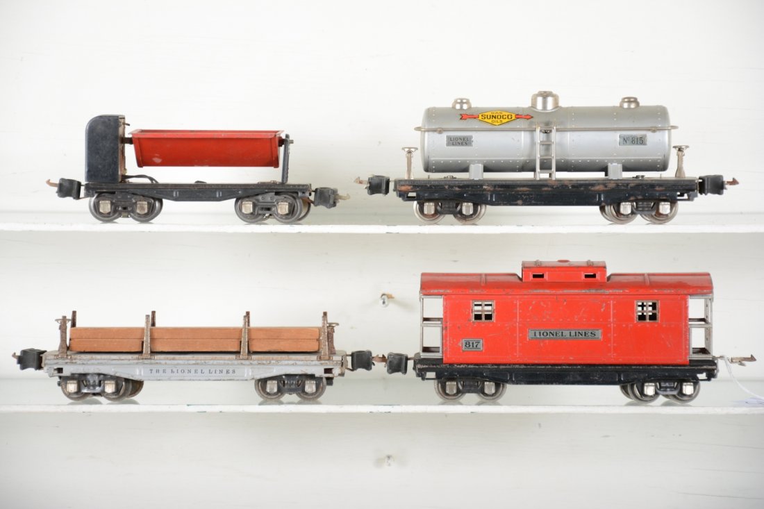 Lionel 2811, 815, 817 & 3659 Freights: Includes a 2811 lumber car; 815 Sunoco tank car 817 late caboose, missing 1 coupler box; 3659 ore dump car. They show moderate playwear, C5+-6