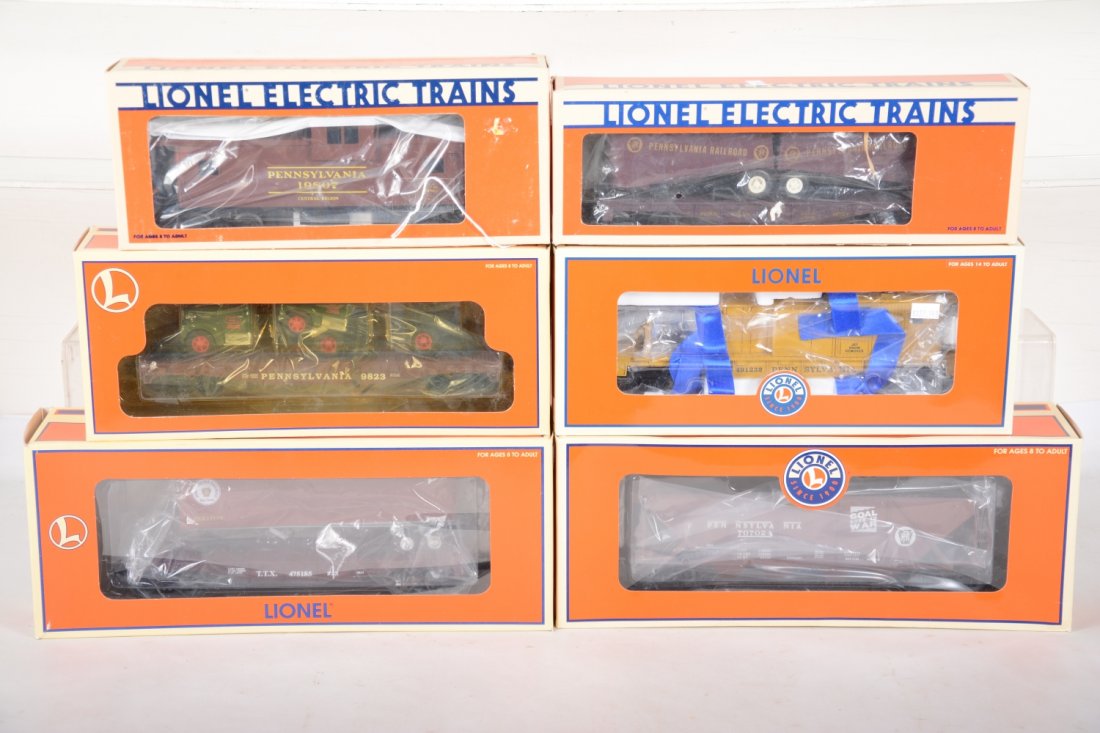 Lionel PRR Freight Cars: Includes a 19807 extended vision smoke caboose; 16303 trailer flat; 52266 LCCA 4-bay hopper; 17518 flat with Ertyl Macs; 26951 trailer flat; 37003 jet snow blower. All appear mint in boxes, C10