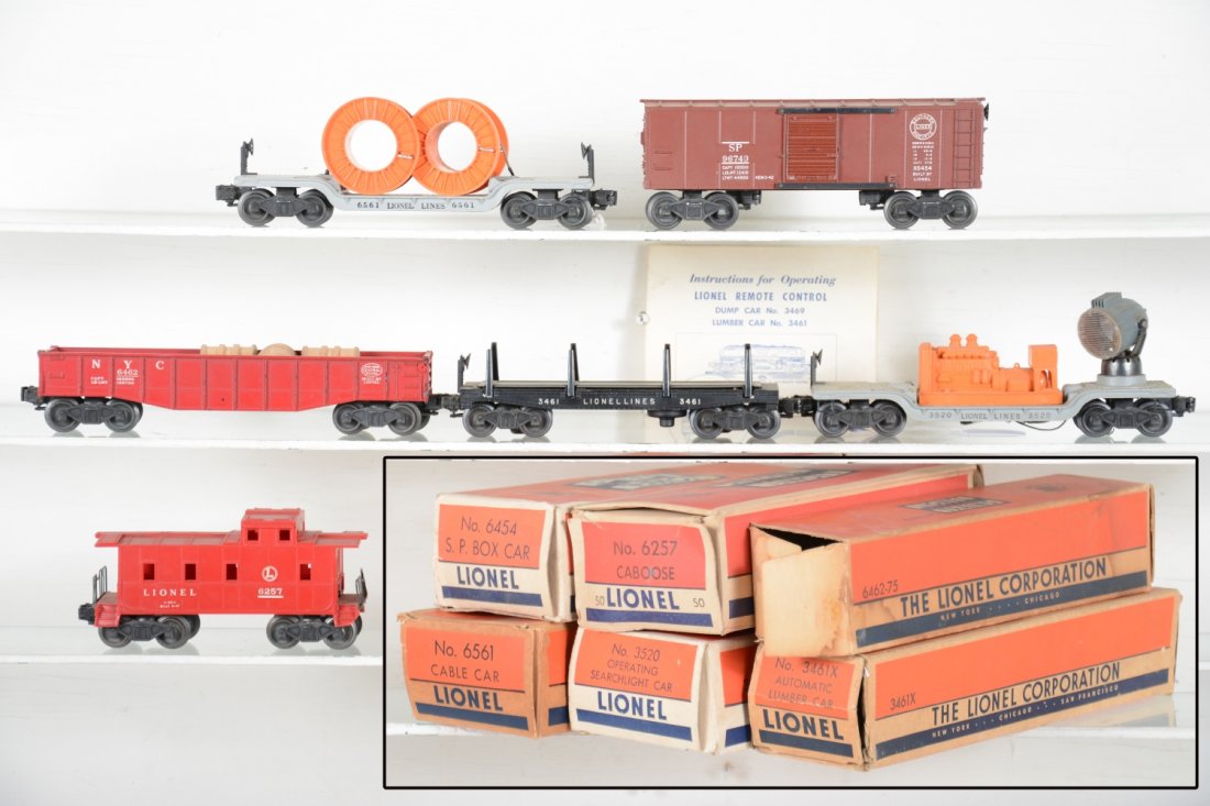 Boxed Lionel Rolling Stock: Includes 3520 searchlight car with instructions; 6454 SP boxcar; 6257-50 SP caboose; 6561 flat with reels, band stretched; 6462-75 red painted gondola with 3 drums; 3461X lumber dump, no logs with ins
