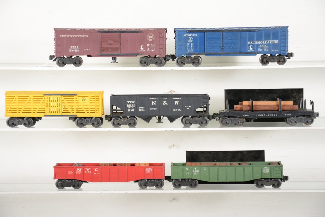 Lionel Rolling Stock: Includes 3484 PRR operating boxcar; 6656 stock car; 6462-25 gondola with barrels; 3456 N&W operating hopper; 3461 log dump car with bin & instructions; 6462-125 gondola with repro barrels; 6468 B&O bo