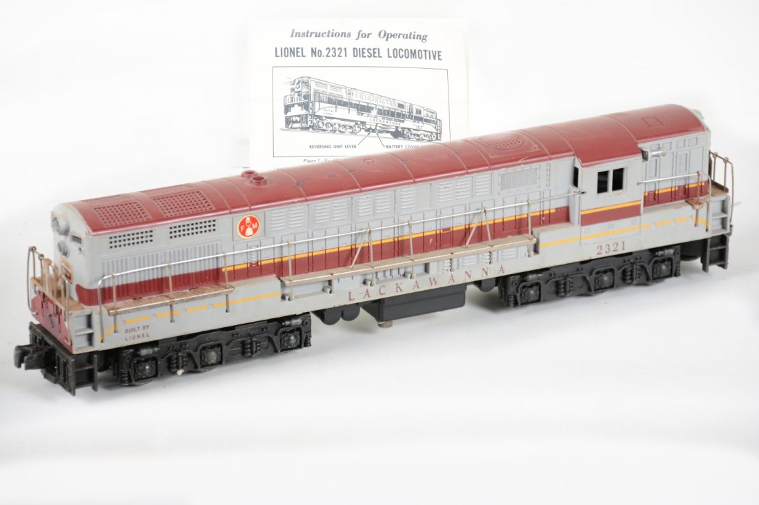 Lionel 2321 Maroon Top Lackawanna FM: Nice dual motor diesel, tougher maroon top version. It has screw cracks both sides with light touch-up there and a bit of rust on some handrails. The battery box shows minor rust spots on bracket insi