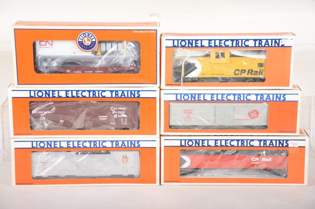 Lionel Canadian Freight Cars: Includes 19705 CP Rail caboose; 17400 CP Rail gondola; 17300 CP Rail reefer; 17200 CP-Rail boxcar; 5719 CN reefer; 26021 CN flat with trailer. All are new in boxes, C10
