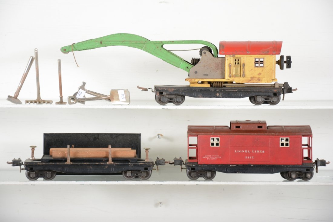 Late Lionel 2800 Freight Cars: Circa 1941 including a scarce deep dish 2810 crane, missing 1 coupler box & hook; 3811 log dump car with bin; 2817 caboose, all HBC, plus 5 Lionel metal tools for a 209 set. All could benefit from a c