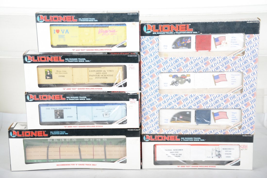 Lionel Freight Cars: Includes 16371 Standard O Burlington flat with wood load; 19599 3-car Old Glory set; 19901 Virginia boxcar; 19506 Newcomen reefer; 19509 Bell reefer; 19509 Di Vinci reefer. All appear new in boxes, C9