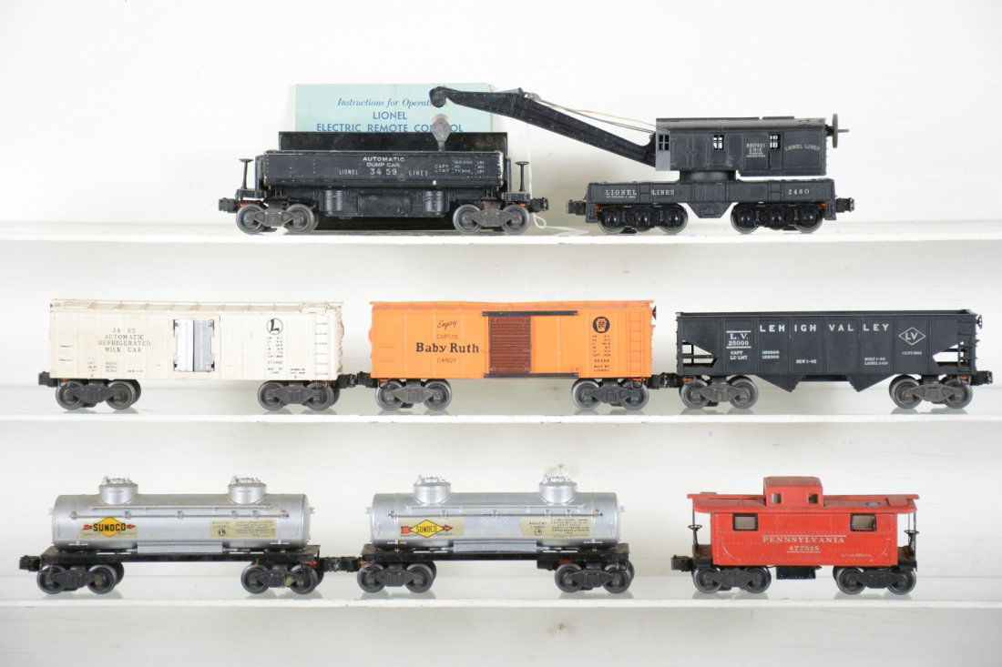 Early Lionel Freight Cars: Includes 2460 6-wheel crane; 3462 milk car only, cans inside; 3459 coal dump with bin; 2454 BR boxcar; 2 #2465 Sunoco tank cars; 2456 LV hopper; 2457 caboose, missing stack. All show light to moderate