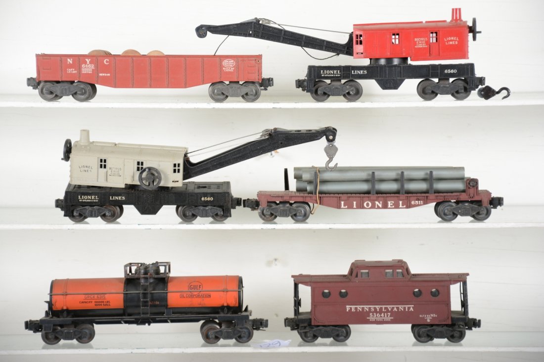 Lionel Freight Cars: Includes a 6315 Gulf chemical tank car, oxi spots on catwalk; 6462 brick red gondola with 3 drums; 6560-25 crane; 6417 PRR N5c caboose; 6511 flat with pipes; 6560 gray cab crane. All could benefit fro