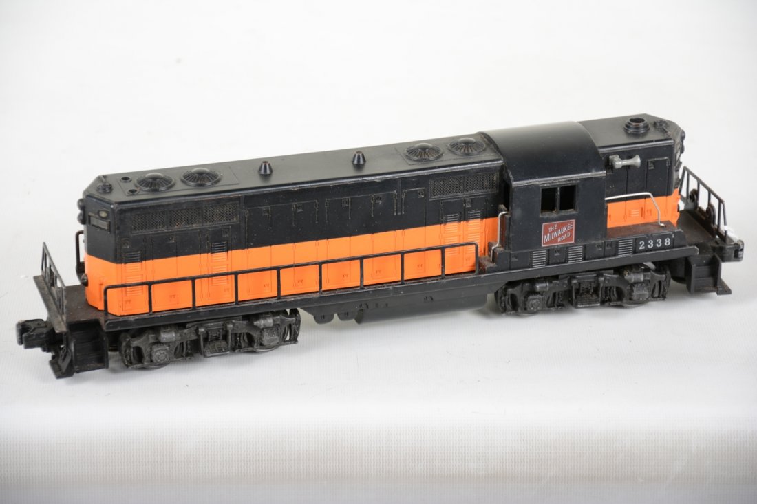 Clean Lionel 2328 MP GP-7 Diesel: Nice black painted on orange mold version. It has nice patina with clean battery box and shows light to moderate playwear, C7