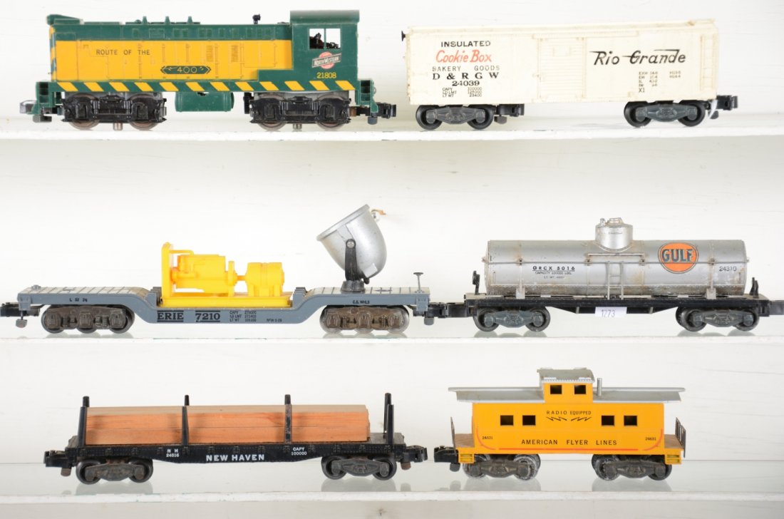 American Flyer 21808 Diesel Freight Set: S Gauge. Includes a 21808 C&NW Baldwin diesel, steps intact, but has screw crack; 24039 Cookie boxcar; 24310 Gulf tank; 24646 searchlight; 24516 NH flat with lumber; 24631 caboose. Rest show light pla