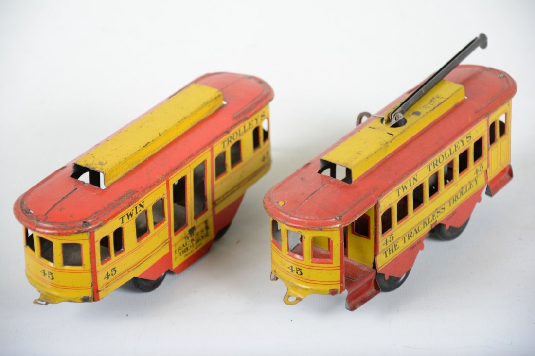 Strauss 45 Trackless Trolleys: Circa 1930s. Clean litho tin trolley pair. Mechanism is functional, though could use adjustment. The powered unit has a broken coupler. They show light to moderate playwear, clean & bright, rest C6+