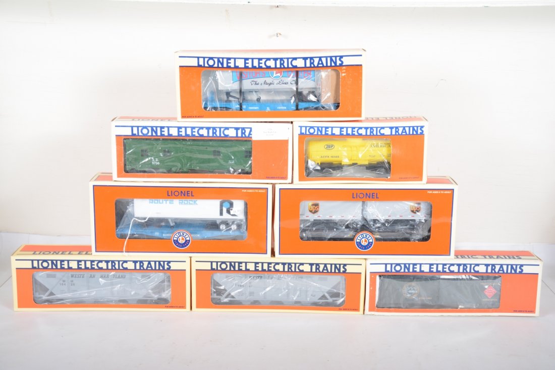Lionel Freight Cars: Includes 26064 RI trailer flat; 16149 Zep tank; 16427 WM hopper; 26300 UPS trailer flat; 16425 WM hopper; 19948 Visitor flat with trailer; 5734 REA reefer; 5726 Southern Bunk car. All appear new in bo