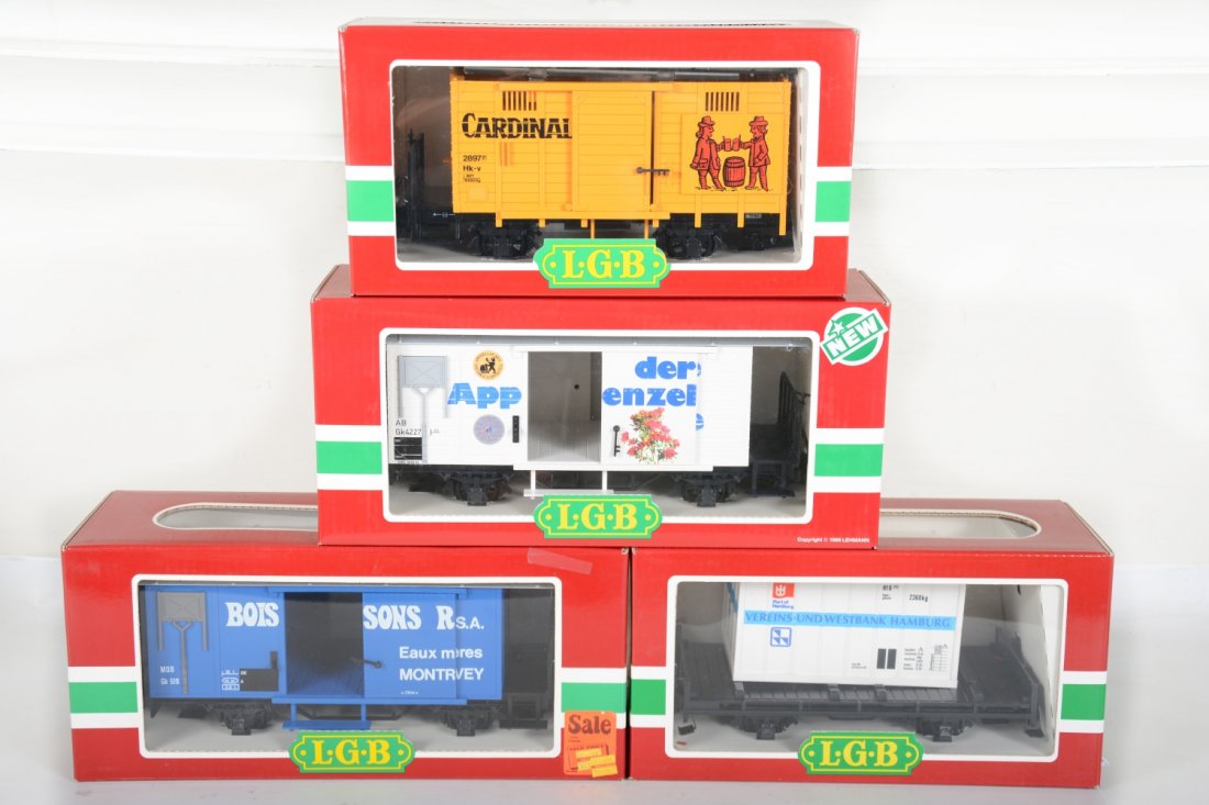 4 LGB 4-Wheel Freight Cars: G Gauge. Includes 4328 Appenzeller reefer; 4029 Boissons' Reefer; 4034 Cardinal reefer; 4003 flat with container. They appear new in boxes, C10
