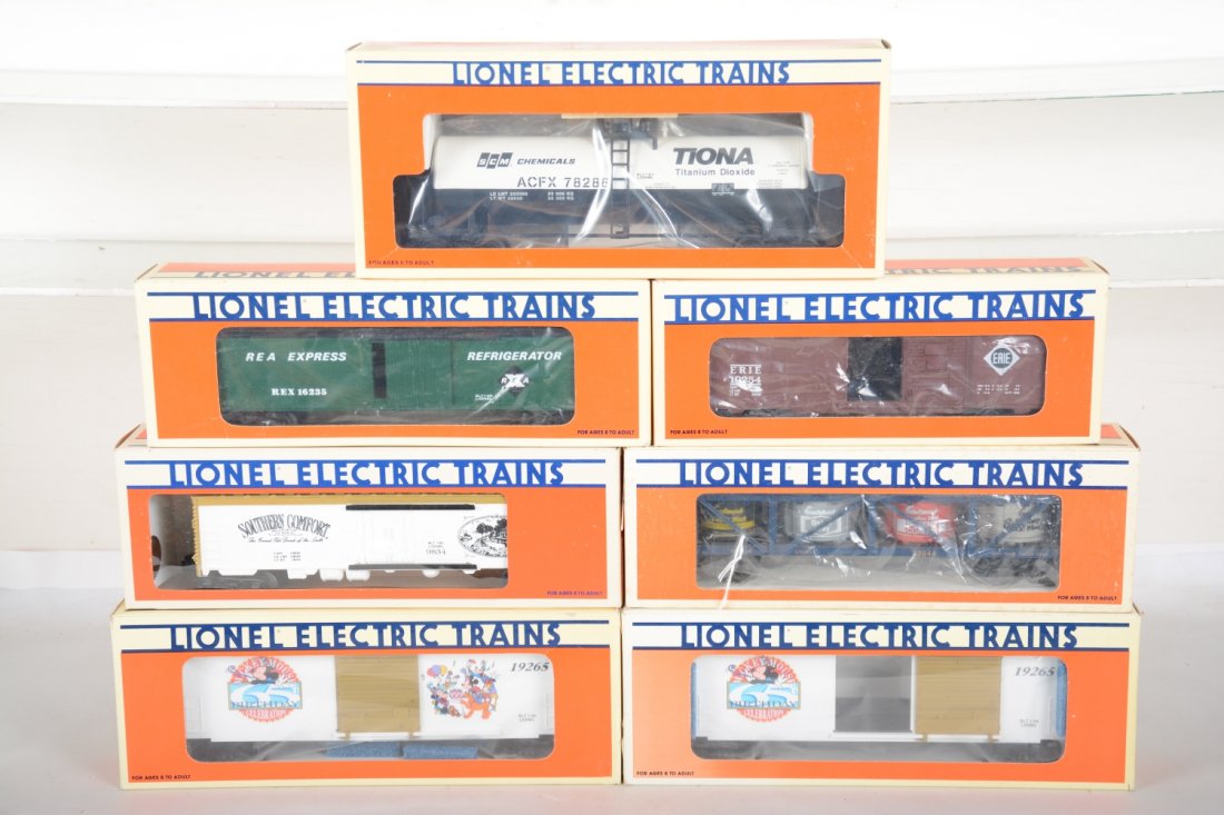 Lionel Freight Cars: Includes 52004 east wood vat car; 19254 Erie boxcar; 9834 Southern comfort reefer; 2 #19265 Mickey mouse Birthday boxcars; 16235 REA reefer; 17906 SMC tank car. All appear new in boxes, C9-10