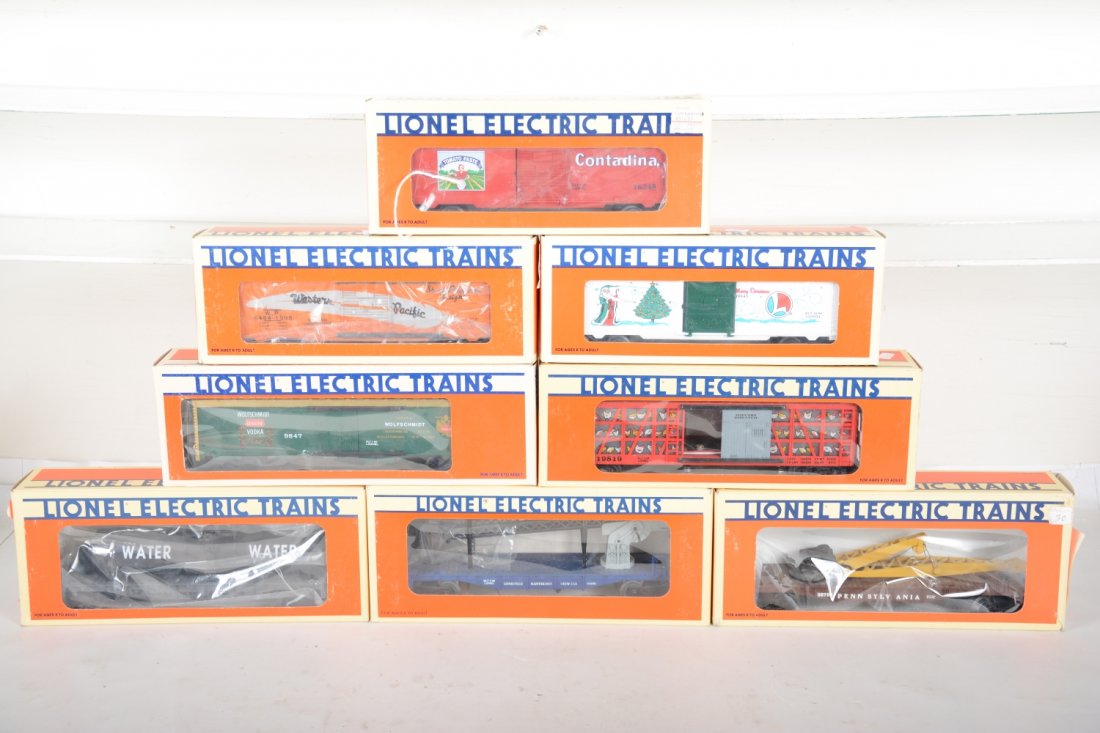 Lionel Freight Cars: Includes 9847 Wolfschmidt reefer; 16390 flat with tank; 52057 WP boxcar; 19945 '96 holiday boxcar; 16245 Contadina boxcar; 19819 poultry dispatch; 16880 cherry picker; 16934 PRR flat with grader. All 