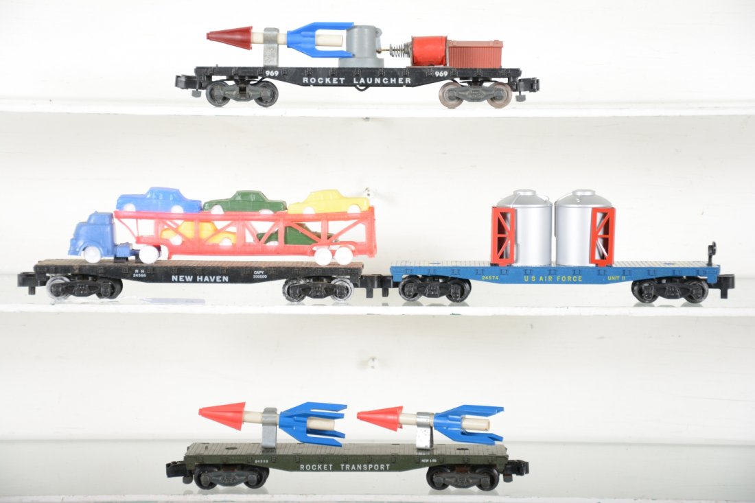 American Flyer Flat Cars: S Gauge. Includes a 969 rocket launcher; 24553 rocket transport; 24574 nuclear waist flat;m24566 auto-loader. All have repro loads and show light playwear, C7-8