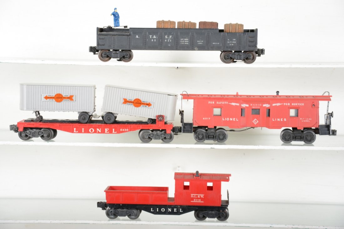 Lionel Freight Cars: Includes 6430 flat with Cooper-Jarrett Vans; 6517 bay window caboose; 3562-1 barrel car, chip on lower edge 1 end; 6119-1 work caboose. Rest show light to moderate playwear, C7
