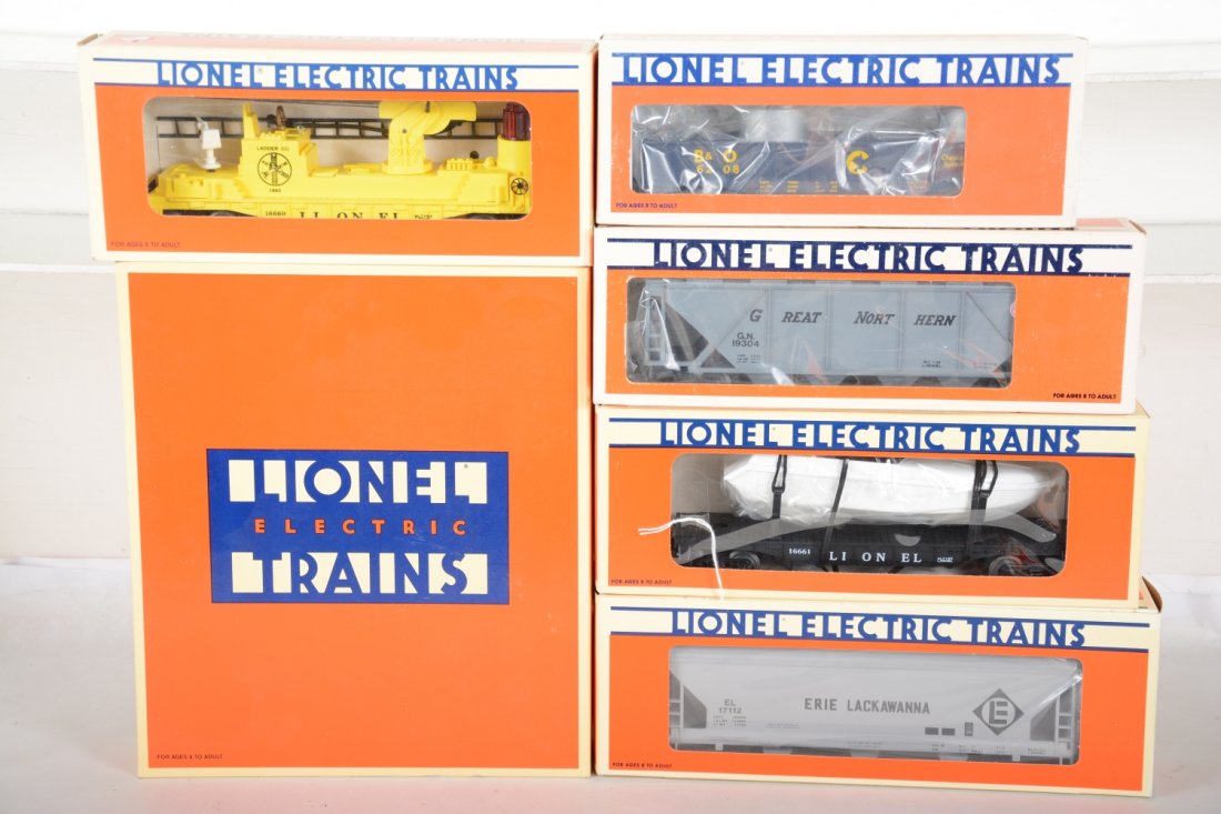 Lionel Freight Cars: Includes 19266 #6464 boxcar series III; 19304 GN covered hopper; 6206 Chessie long gondola; 16661 flat with operating boat; 16660 fire ladder car, missing figure; 17112 Erie hopper. Rest appear new in