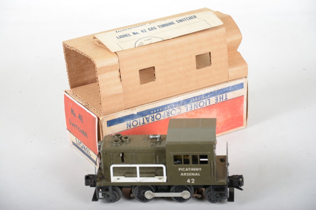 Clean Boxed Lionel 42 Picatinny Arsenal: Nice military diesel with intact struts. It has a nice shiny finish, bright rods and only a few small paint chips on handrail bases. It has a clean box with insert, 1 missing flap. It shows light play