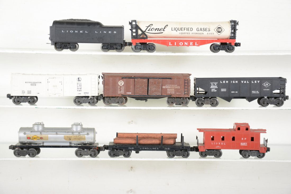 Lionel Rolling Stock: Includes 6469 liquefied gasses car, tube dented; 3451 log dump, missing 1 stake; 6472 reefer; 1130T tender; 2458 boxcar, C5; 6257 caboose; 6456 hopper; 6465 tank car. Rest show light to moderate playw