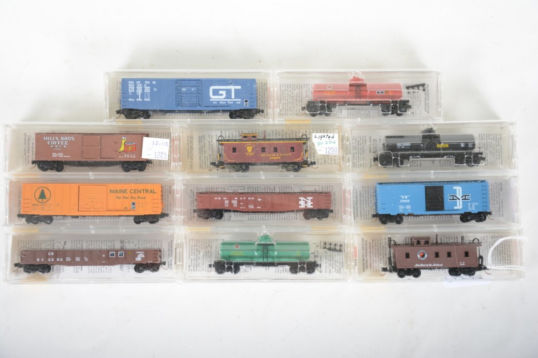 11 Micro-Trains N Gauge Freight Cars: Nice assortment including a lighted caboose. Most are new in boxes, C9-10