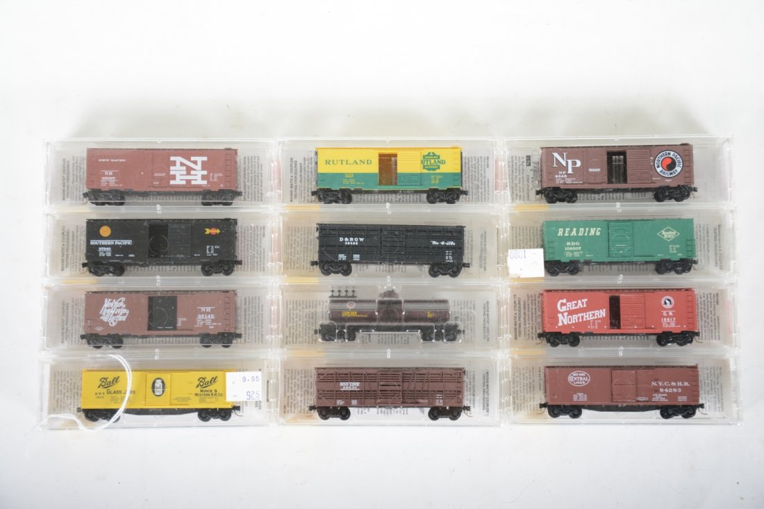 12 Micro-Trains N Gauge Freight Cars: Nice assortment including a lighted caboose. Most are new in boxes, C9-10
