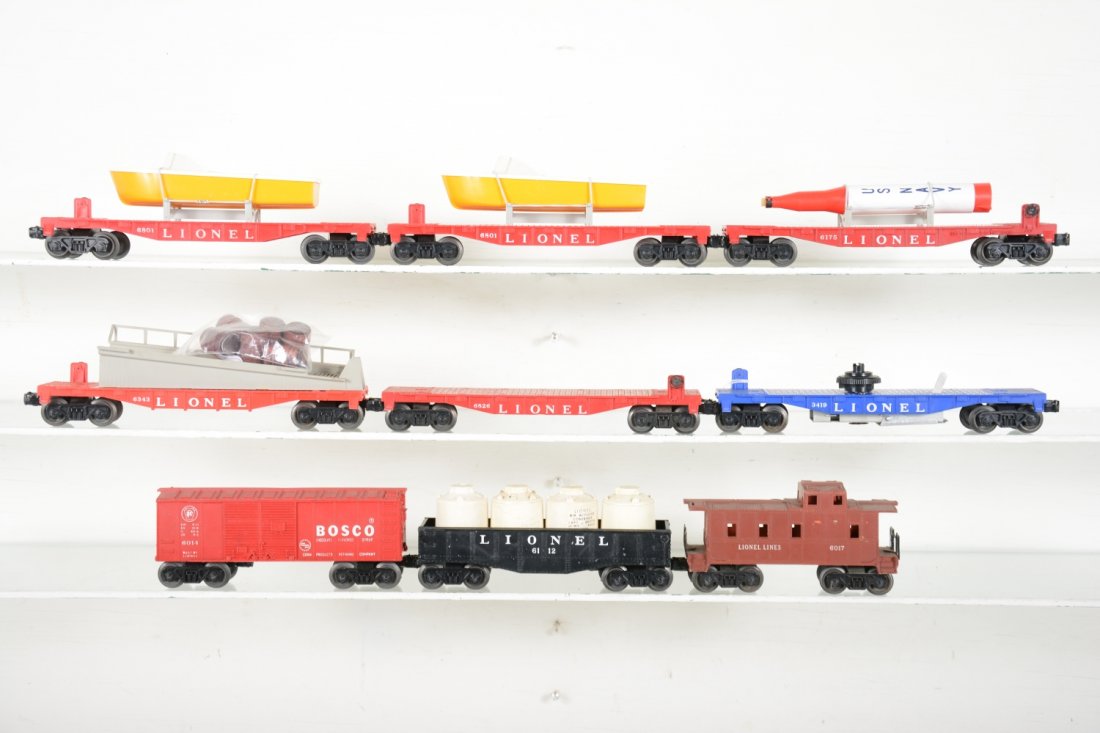 Lionel Rolling Stock: Includes 2 #6801-75 flats with repro boats; 6343 barrel ramp car; 6014 Bosco boxcar; 6175 flat with repro rocket; 6112 gondola with canisters; 6826 empty flat; 3419 incomplete flat; 6017 caboose. All 