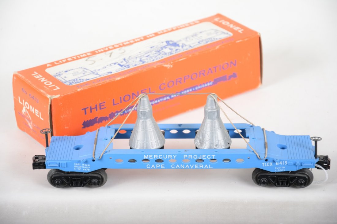Boxed Lionel 6413 Mercury Capsule Carrying Car: Clean and all original car with bands and tie rod. 1 capsule is dented, otherwise shows light playwear with nice box, C8 ish.