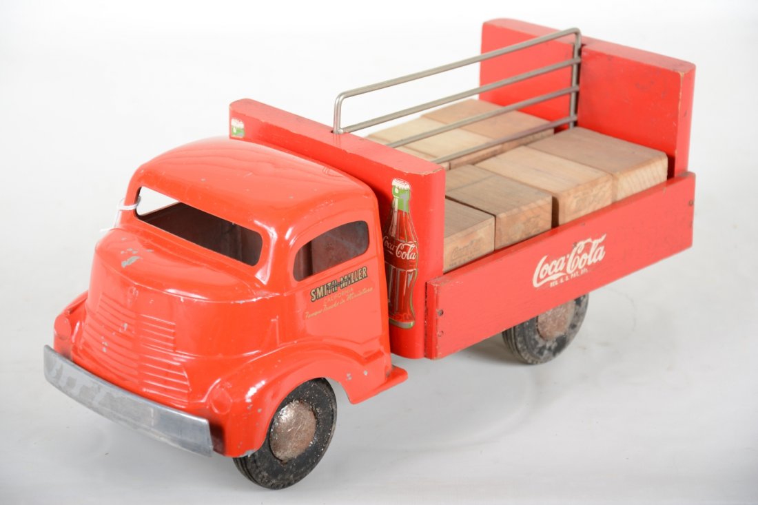 Nice Smith-Miller GMC Coca-Cola Truck: Painted & decaled diecast and wood, 14" long. Clean & shiny with nice graphics all around. The nickel is bright and it sill retains 8 original Coke wooden crates. It shows light to moderate playwear,