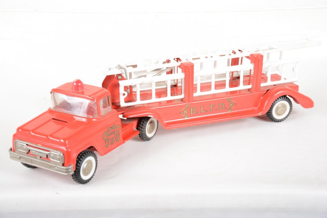 Clean Buddy L Aerial Ladder Truck: Circa 1965. 26" long. Shiny and complete with just a repaired bubble light cap. It shows very light playwear, otherwise C8+-9. Nice.