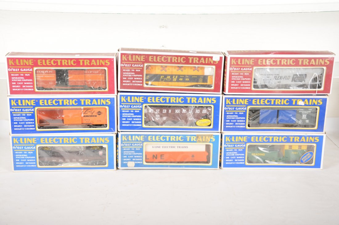 9 K-Line Freight Cars: Includes 7351 boom car; 662802 cannon flat; 5712 auto-car; 6269 hopper; 5715 auto-car; 6457 mail car; 6528 gondola; 6515 gondola; 90008 Flexiflo hopper. All appear new in lightly shop worn boxes, C9