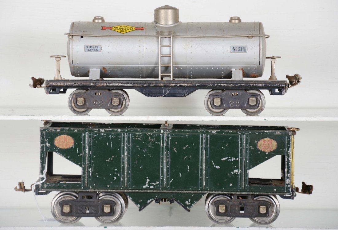 Lionel 216 & 515 Freight Cars: Standard gauge. Includes a brass 216 hopper, missing top dump wheel; late 515 Sunoco tank car. Both show moderate playwear, should clean to C5+-6