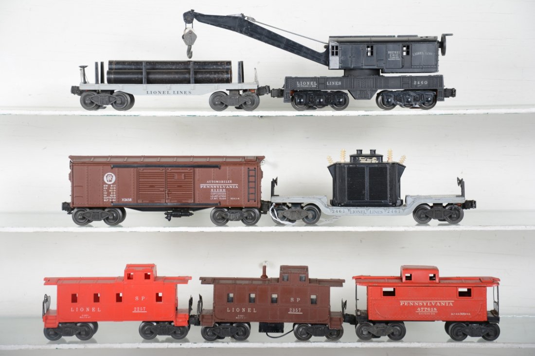 Early Lionel Freight Cars: Includes 2458 PRR boxcar; 2460 6-wheel crane; 2257 caboose; 2357 caboose, missing stack tip; 2472 caboose; 2461 flat with transformer, 1 reattached insulator; 2411 flat with original pipes. They show 