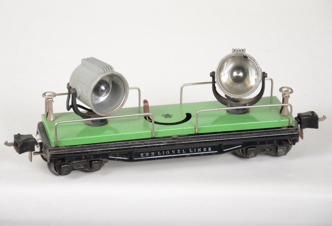 Scarce Lionel 2820 Searchlight Car: 1941 version with cast yokes and gray cast searchlights. It is clean with 1 replaced lens, showing light to moderate playwear, C7