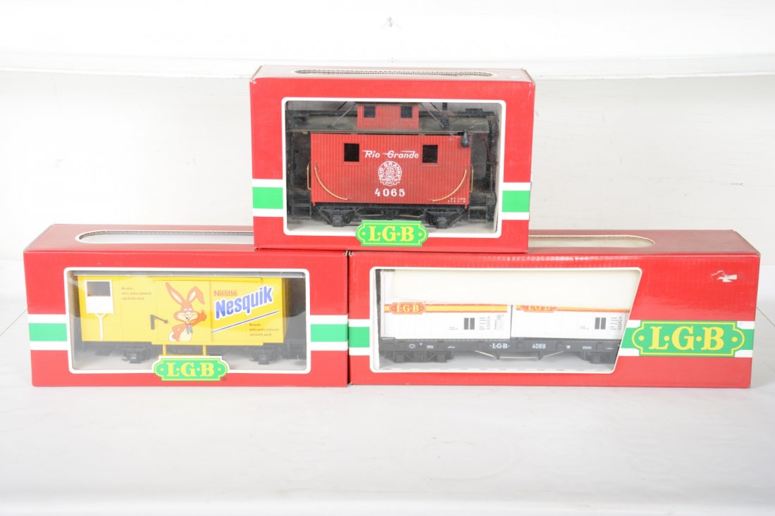 3 LGB Freight Cars: G Gauge. Includes a 4065 RG caboose, ob C8; 4069 container flat; 45280 Nesquik goods wagon. Rest appear like new with boxes, C10