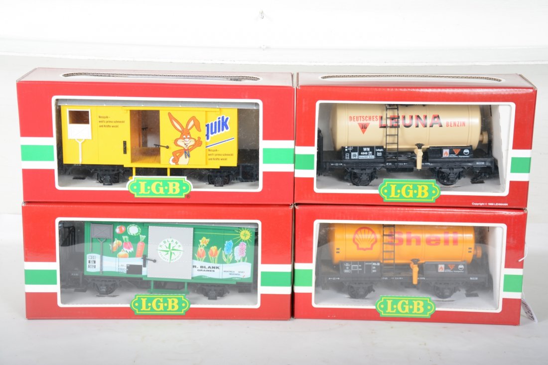 4 LGB Freight Cars: G Gauge. Includes 4040L Luna Tank car; 45280 Nesquik goods wagon; 4040S Shell tank car; 4128 R. Black Grains goods wagon. They show light runtime with C9 bodies with boxes.