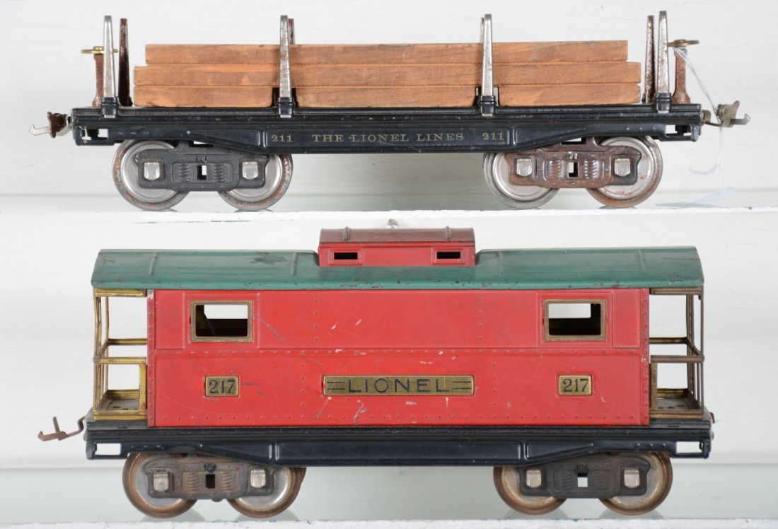 Lionel 211 & 217 Freight Cars: Standard gauge. Includes a 211 lumber car, some rust on 1 truck; 217 caboose, both showing light to moderate playwear, otherwise C6-7