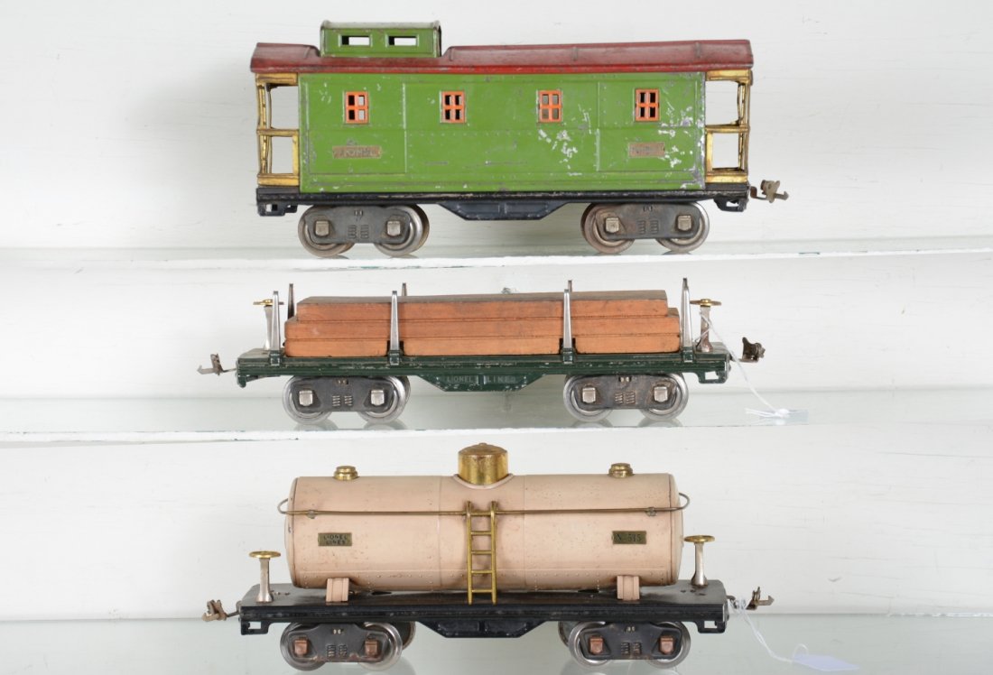 Lionel 511, 515 & 517 Freight Cars: Standard Gauge. Includes a 511 lumber with 517 caboose showing moderate playwear, C5-6; 515 Ivory tank, showing light to moderate playwear, dirty, C6+